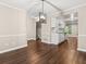 Dining area with hardwood floors and modern lighting leading to a kitchen at 95 Ivy Ne Trl, Atlanta, GA 30342