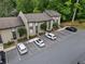 A well-maintained condo building exterior with parking and surrounding greenery, creating a serene environment at 95 Ivy Ne Trl, Atlanta, GA 30342
