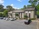 A well-maintained condo building exterior with parking and surrounding greenery, creating a serene environment at 95 Ivy Ne Trl, Atlanta, GA 30342