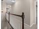 Hallway with carpet and brown and white banister at 95 Ivy Ne Trl, Atlanta, GA 30342