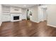 Cozy living room boasts hardwood floors, built-in bookshelves, and a fireplace with white mantle at 95 Ivy Ne Trl, Atlanta, GA 30342