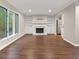 Spacious living room with fireplace and hardwood flooring adjacent to kitchen at 95 Ivy Ne Trl, Atlanta, GA 30342