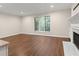 Spacious living room features hardwood floors, a fireplace, and a large window overlooking the greenery at 95 Ivy Ne Trl, Atlanta, GA 30342