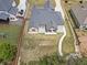 Aerial view showing the fenced-in yard, brick home, outdoor patio, and exterior landscaping at 953 Auburn Rd, Dacula, GA 30019