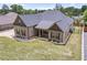 Aerial view showcasing the home's roof, brick exterior, manicured lawn, and surrounding landscaping at 953 Auburn Rd, Dacula, GA 30019