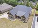Aerial view of a brick home with a well-manicured lawn, landscaping, and an asphalt driveway at 953 Auburn Rd, Dacula, GA 30019