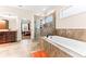 Relaxing bathroom with a soaking tub, walk-in shower, and view into the main bedroom at 953 Auburn Rd, Dacula, GA 30019