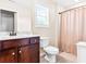 Bright bathroom features a tiled floor, a shower and a vanity with a large sink at 953 Auburn Rd, Dacula, GA 30019
