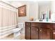 Bathroom showcasing a dark wood vanity with white countertop and a shower with patterned curtain at 953 Auburn Rd, Dacula, GA 30019