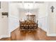 A formal dining room with wainscoting, coffered ceilings and hardwood floors at 953 Auburn Rd, Dacula, GA 30019