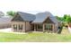 Beautiful brick home with a covered porch and well-maintained landscaping at 953 Auburn Rd, Dacula, GA 30019