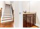 Elegant hallway showcasing wood stairs, a granite topped side bar, and rich flooring at 953 Auburn Rd, Dacula, GA 30019
