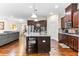 The spacious kitchen features a large island with granite countertops and stainless steel appliances at 953 Auburn Rd, Dacula, GA 30019