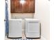 Convenient laundry room with modern washer and dryer, ample storage, and neutral flooring at 953 Auburn Rd, Dacula, GA 30019
