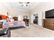 Comfortable and well-lit main bedroom with seating area and an ensuite bathroom at 953 Auburn Rd, Dacula, GA 30019