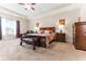 A spacious main bedroom boasts tray ceilings, a king bed, and a sitting area with lots of light at 953 Auburn Rd, Dacula, GA 30019
