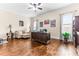 A spacious office area with hardwood floors, natural light, and a comfortable lounge chair at 953 Auburn Rd, Dacula, GA 30019