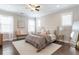 Bright bedroom with neutral tones, hardwood floors, and a large bed at 1085 Celebration Dr, Roswell, GA 30076