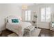Cozy bedroom with light wood floors, white walls, and ample natural light at 1085 Celebration Dr, Roswell, GA 30076