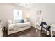 Cozy bedroom with daybed, white walls, wood floors, and a large mirror at 1085 Celebration Dr, Roswell, GA 30076