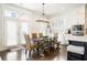Bright dining area featuring a wooden table, kitchen bar, and stainless steel appliances at 1085 Celebration Dr, Roswell, GA 30076