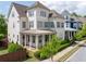 Charming two-story home with a covered front porch and manicured landscaping at 1085 Celebration Dr, Roswell, GA 30076
