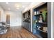 Hallway featuring dark wood floors, built-in shelves and cabinets with display lighting at 1085 Celebration Dr, Roswell, GA 30076