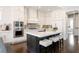 Spacious kitchen with a large center island, stainless steel appliances, and custom cabinetry at 1085 Celebration Dr, Roswell, GA 30076