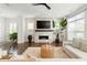 Bright living room with a modern fireplace, large windows, and stylish decor at 1085 Celebration Dr, Roswell, GA 30076