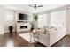 Bright living room featuring a modern fireplace, plush seating, and large windows at 1085 Celebration Dr, Roswell, GA 30076