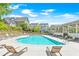 Enjoy the community pool with plenty of lounge chairs for relaxation on a sunny day, surrounded by lush landscaping at 1085 Celebration Dr, Roswell, GA 30076