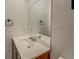 Clean bathroom featuring a large mirror, dark wood cabinets, and a white countertop sink at 115 Plantation Dr, Clarkston, GA 30021
