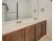 Bathroom features a double sink vanity with dark wood cabinets and a large mirror at 115 Plantation Dr, Clarkston, GA 30021