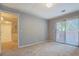 Spacious bedroom with sliding glass doors and neutral color scheme, offering a blank canvas for personalization at 115 Plantation Dr, Clarkston, GA 30021