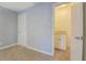 Neutral-toned bedroom with carpet and closet space, adjoined to a vanity and sink area via a connecting door at 115 Plantation Dr, Clarkston, GA 30021