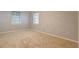 Inviting bedroom with two windows, neutral walls, and carpet flooring, offering a cozy and serene atmosphere at 115 Plantation Dr, Clarkston, GA 30021