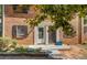 Charming brick home showcasing a well-kept lawn with landscaped beds and a welcoming front entrance at 115 Plantation Dr, Clarkston, GA 30021