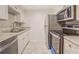 Modern kitchen with stainless steel appliances, including a microwave, range, and refrigerator, complemented by granite countertops at 115 Plantation Dr, Clarkston, GA 30021