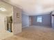 Bright living space opens to kitchen with tile flooring, stainless steel appliances, and neutral walls at 115 Plantation Dr, Clarkston, GA 30021