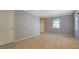 Neutral interior with plush carpeting, a window, a door, and ample natural light at 115 Plantation Dr, Clarkston, GA 30021