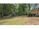 A spacious backyard with a playhouse and lush greenery at 4524 Shumart Dr, Snellville, GA 30039