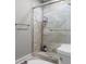 Modern bathroom shower featuring decorative stone tile, glass door, and dual shower heads at 4524 Shumart Dr, Snellville, GA 30039