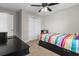 Cozy bedroom with a bright bedspread, a dark desk, and a closet at 4524 Shumart Dr, Snellville, GA 30039
