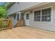Spacious wooden deck with white trim and stairs leading to a lush backyard at 4524 Shumart Dr, Snellville, GA 30039