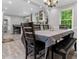 Inviting dining area with seating for six, a contemporary chandelier, and hardwood floors at 4524 Shumart Dr, Snellville, GA 30039