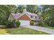 Lovely home featuring a brick-accented facade, a two-car garage, and a welcoming front porch at 4524 Shumart Dr, Snellville, GA 30039