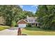Charming two-story home with brick accents, a well-manicured lawn, and a spacious two car garage at 4524 Shumart Dr, Snellville, GA 30039