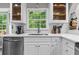 Updated kitchen featuring white cabinets, stainless steel appliances and stylish backsplash at 4524 Shumart Dr, Snellville, GA 30039