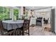 Bright kitchen with stainless steel appliances, white cabinets and island and wood floors throughout at 4524 Shumart Dr, Snellville, GA 30039