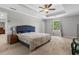 Spacious main bedroom with neutral colors, carpet flooring, and recessed ceiling with fan at 4524 Shumart Dr, Snellville, GA 30039